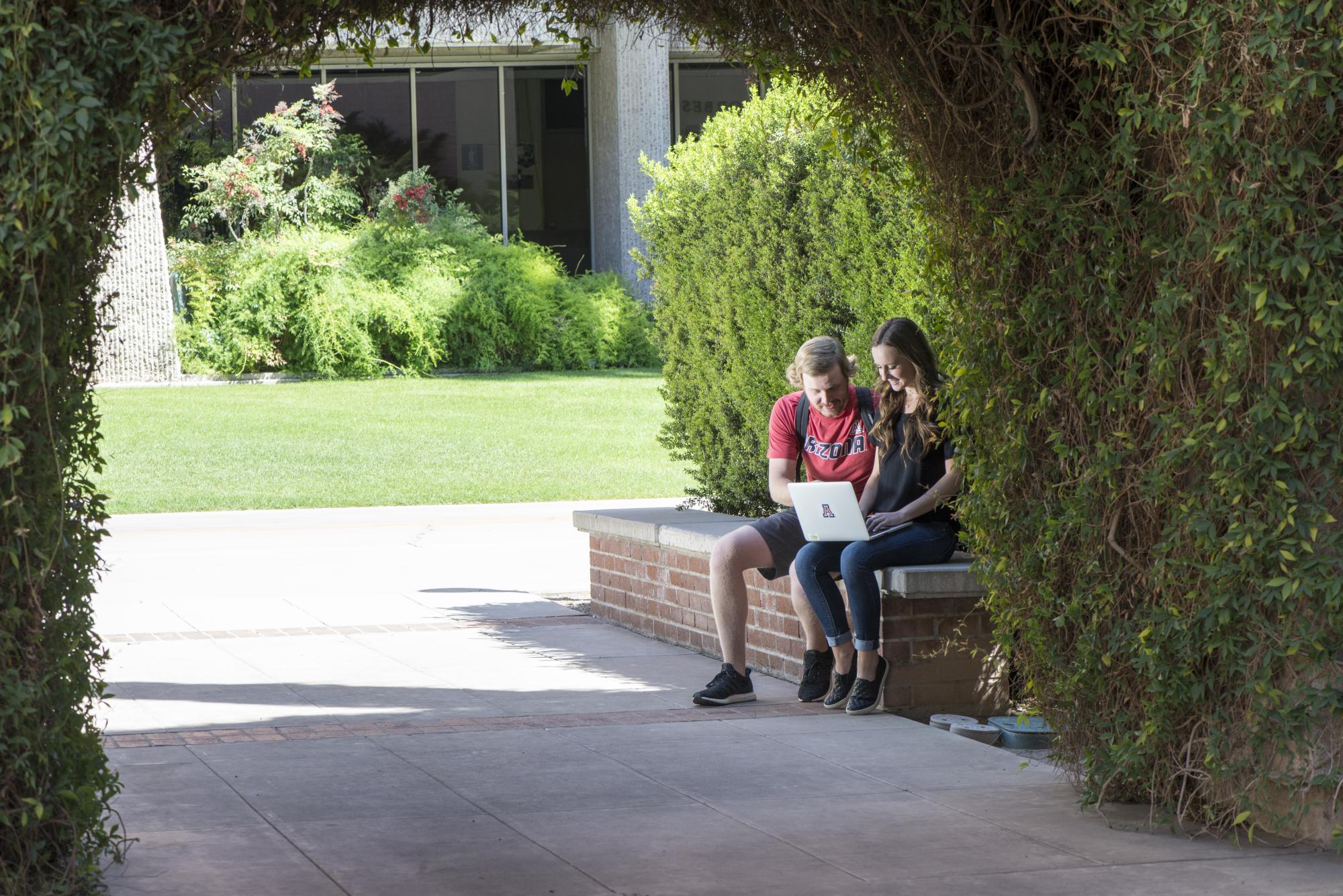 Two students sitting on bench